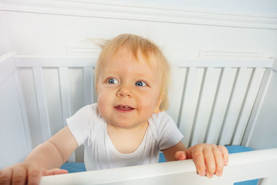 Portrait of cute baby girl sitting on table