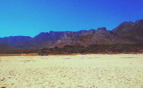 Scenic view of mountains against clear blue sky