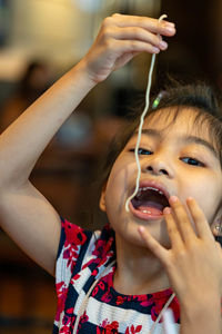 Cute girl eating food at restaurant