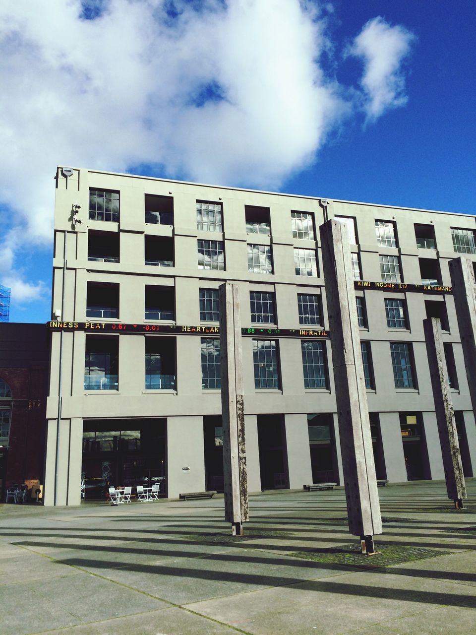 building exterior, architecture, built structure, sky, cloud - sky, window, low angle view, cloud, building, city, facade, day, residential building, sunlight, residential structure, outdoors, blue, street, cloudy, shadow