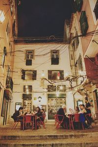 People in front of illuminated building at night