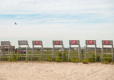 Information sign against sky