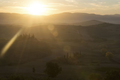 Scenic view of silhouette mountains against sky at sunset