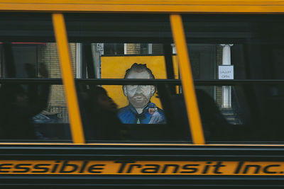 Portrait of man seen through train window