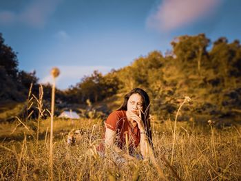 Young woman sitting on field