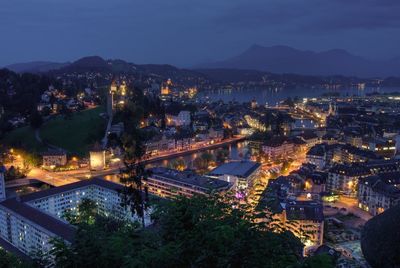 Aerial view of city lit up at night