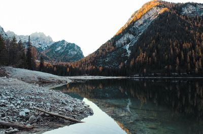 Scenic view of lake and mountains against clear sky