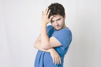 Portrait of man standing against white background