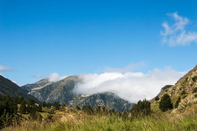 Scenic view of mountains against blue sky