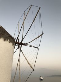 Windmill by sea against clear sky in mykonos town