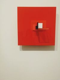 Close-up of red mailbox on white wall