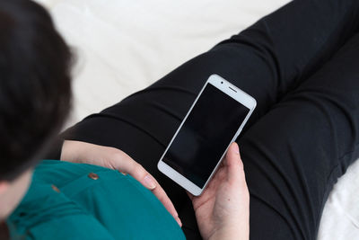 Midsection of woman using mobile phone