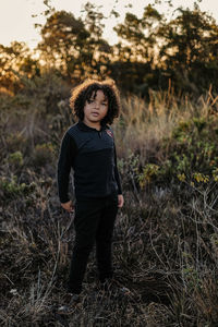 Portrait of girl standing on field