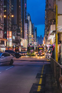 View of city street and buildings at night