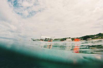 Boats in sea against sky