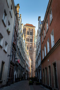 Low angle view of buildings in town against sky