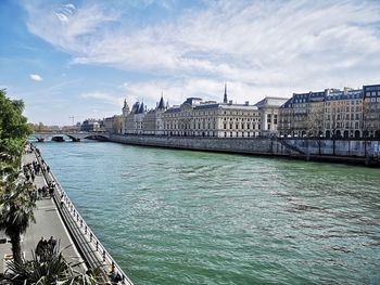 Bridge over river with city in background