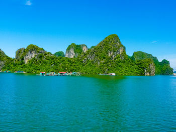 Scenic view of bay against clear blue sky