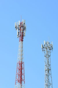 Low angle view of communications tower against blue sky