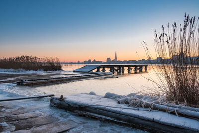 Scenic view of snow against sky during sunset