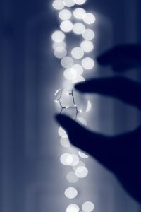 Close-up of hand on illuminated lights