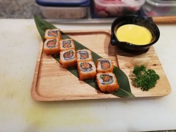 High angle view of sushi with dip on table