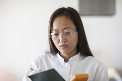 Scientist female with lab glasses and tablet in a lab