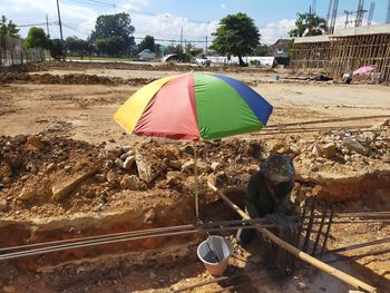 People working on road amidst land