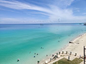 Group of people on beach against sky