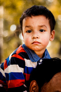 Portrait of cute boy with father outdoors