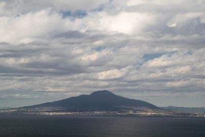 Scenic view of sea and mountains against sky