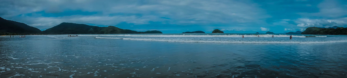 Panoramic view of beach against blue sky