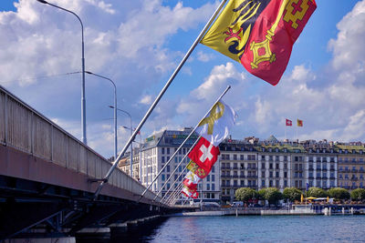 Bridge over river in city against sky