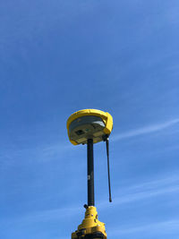 Low angle view of street light against blue sky