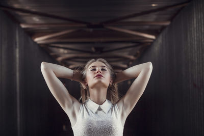 Close-up of seductive young woman standing in corridor