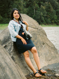 Young woman standing on rock