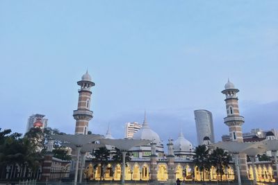 View of buildings in city against clear sky