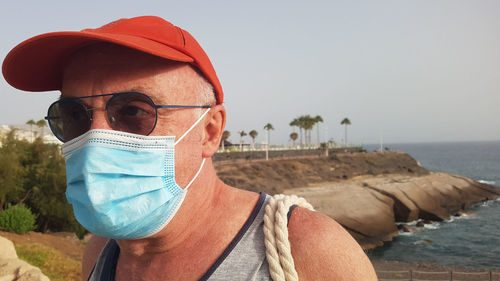 Portrait of senior man in sea against sky