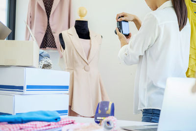 Woman photographing clothing