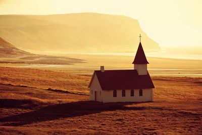 Church on field against mountain