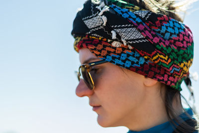 Side view of woman wearing headscarf looking away