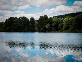 Scenic view of swimming pool by lake against sky