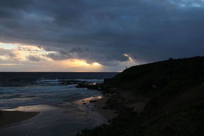 Scenic view of beach against sky during sunset