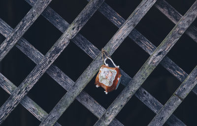 Coffee cup hanging on wooden fence