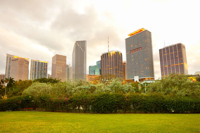 Scenic view of trees and buildings against sky