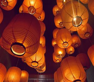 Low angle view of illuminated lanterns hanging on ceiling