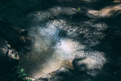 High angle view of water flowing through rocks