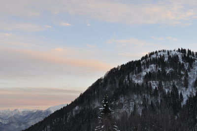 Scenic view of snowcapped mountains against sky during sunset