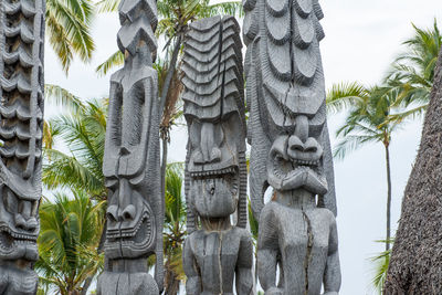 Panoramic shot of sculptures on tree trunk