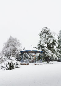 Built structure on snow covered landscape against clear sky